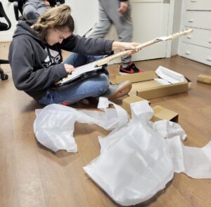 Teen girl putting together a guitar