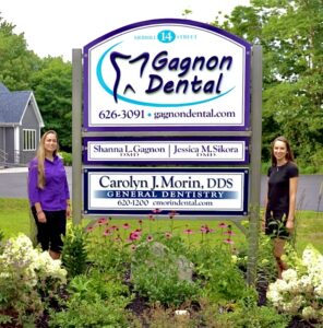 Shanna Gagnon with the Gagnon Dental sign in Farmingdale